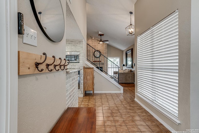 13426 Marceline, San Antonio, TX 78232 - hall featuring stairway, lofted ceiling, a chandelier, and light tile patterned floors