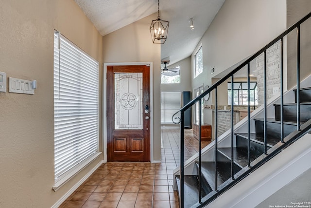 13426 Marceline, San Antonio, TX 78232 - foyer entrance featuring stairway, a chandelier, tile patterned flooring, a ceiling fan, and a textured wall