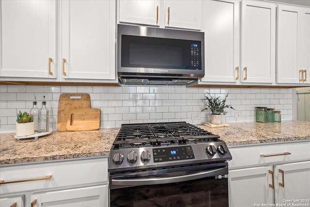 9702 Tupelo Holw, San Antonio, TX 78254 - kitchen with stainless steel appliances, white cabinetry, backsplash, and light stone countertops