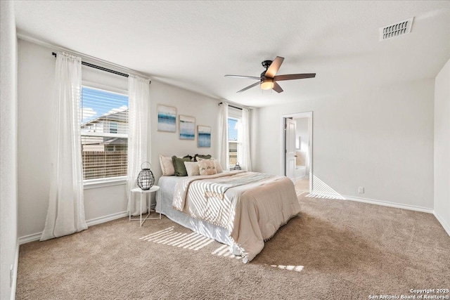 9702 Tupelo Holw, San Antonio, TX 78254 - carpeted bedroom with baseboards, a ceiling fan, and connected bathroom