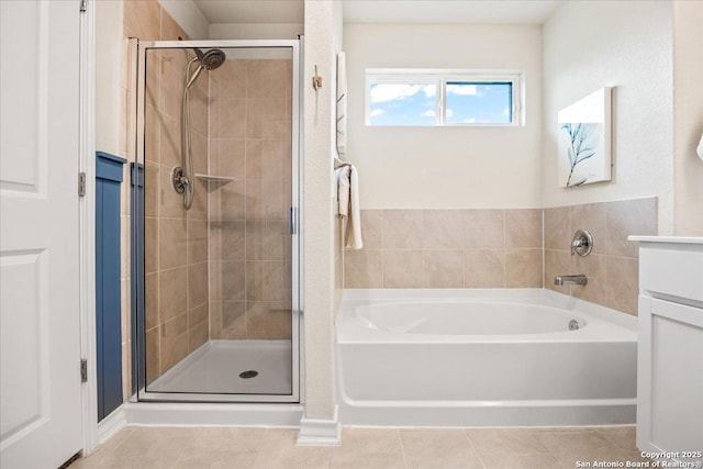 9702 Tupelo Holw, San Antonio, TX 78254 - bathroom featuring a stall shower, a bath, and tile patterned flooring