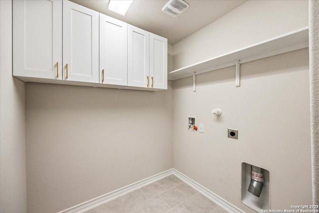9702 Tupelo Holw, San Antonio, TX 78254 - laundry area featuring cabinet space, hookup for an electric dryer, washer hookup, baseboards, and gas dryer hookup