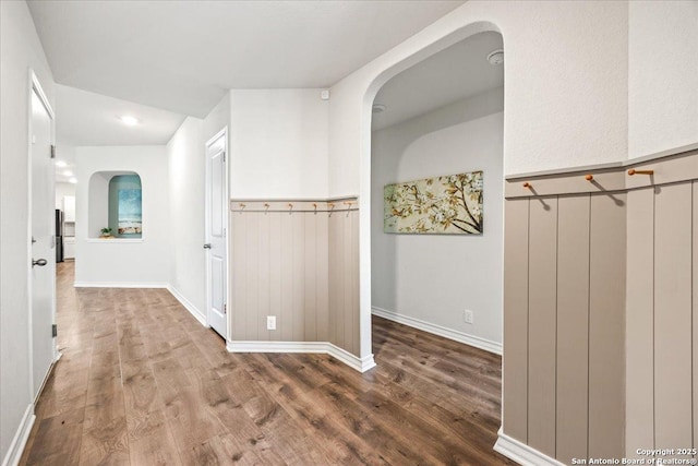 9702 Tupelo Holw, San Antonio, TX 78254 - hall with wood finished floors, arched walkways, wainscoting, and baseboards