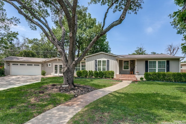247 Brightwood Pl, San Antonio, TX 78209 - ranch-style house with concrete driveway, an attached garage, a front lawn, and board and batten siding
