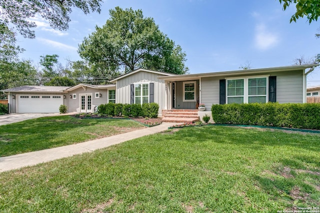 247 Brightwood Pl, San Antonio, TX 78209 - single story home with a garage, board and batten siding, a front yard, concrete driveway, and french doors
