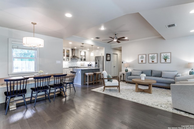 247 Brightwood Pl, San Antonio, TX 78209 - living area featuring dark wood-style floors, a ceiling fan, recessed lighting, and crown molding