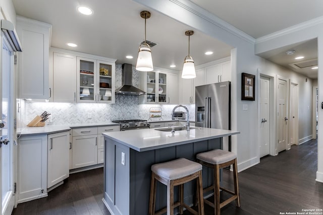 247 Brightwood Pl, San Antonio, TX 78209 - kitchen with a sink, wall chimney exhaust hood, appliances with stainless steel finishes, crown molding, and dark wood finished floors