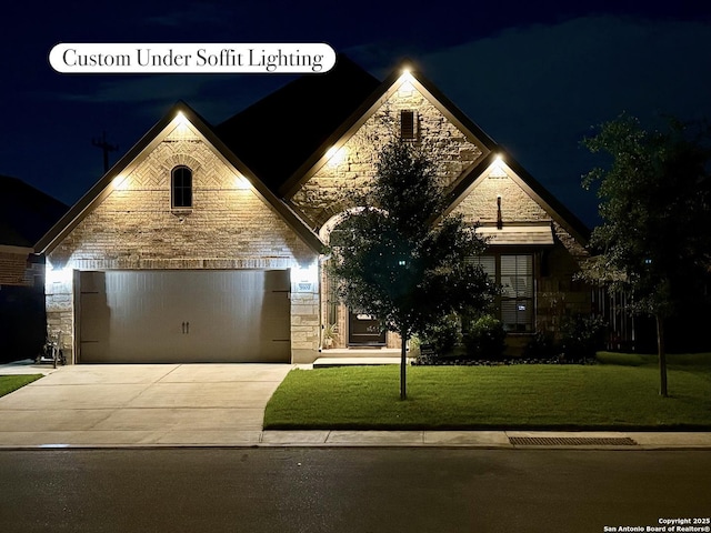 9102 War Wagon, San Antonio, TX 78254 - view of front facade with stone siding, driveway, and a lawn