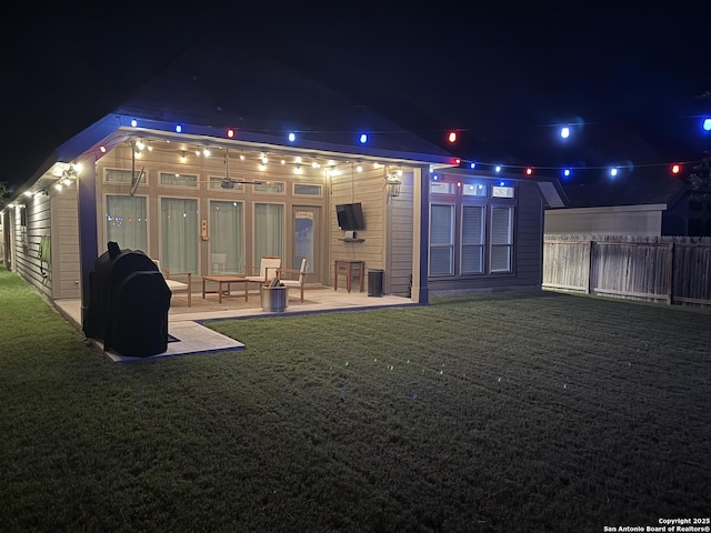 9102 War Wagon, San Antonio, TX 78254 - back of house at night featuring a patio area