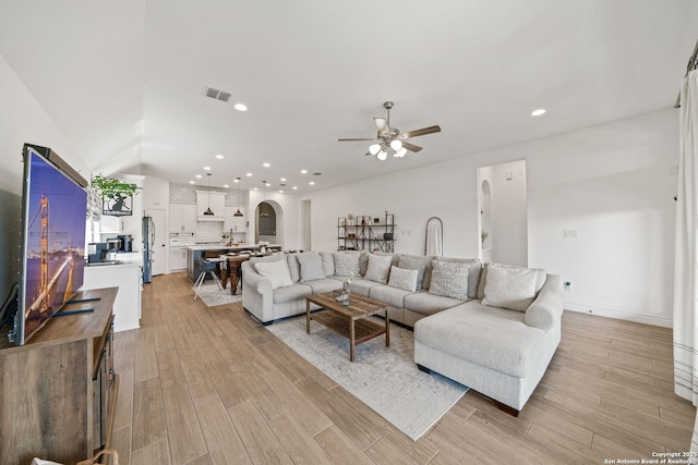 9102 War Wagon, San Antonio, TX 78254 - living area featuring a ceiling fan, light wood-type flooring, recessed lighting, and arched walkways