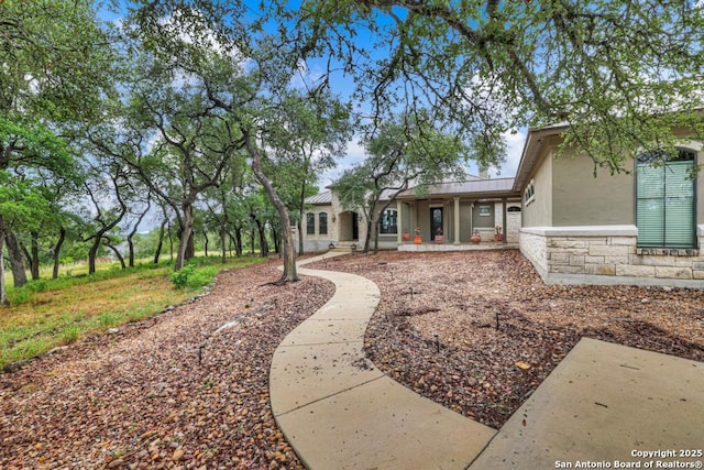 835 Shady Holw, New Braunfels, TX 78132 - rear view of house featuring stucco siding, stone siding, and covered porch
