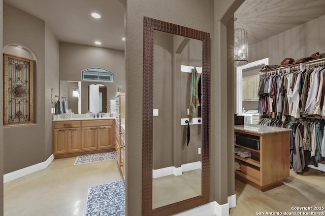 835 Shady Holw, New Braunfels, TX 78132 - full bath with vanity, a walk in closet, baseboards, and recessed lighting