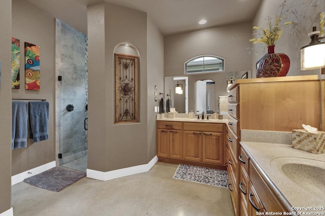 835 Shady Holw, New Braunfels, TX 78132 - bathroom featuring concrete floors, two vanities, a shower stall, and baseboards