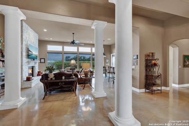 835 Shady Holw, New Braunfels, TX 78132 - living area featuring ornate columns, a ceiling fan, finished concrete flooring, a stone fireplace, and recessed lighting