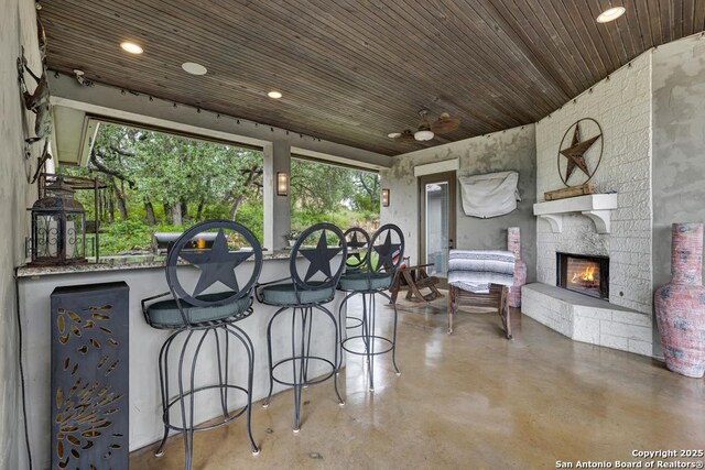 835 Shady Holw, New Braunfels, TX 78132 - view of patio featuring an outdoor stone fireplace and ceiling fan
