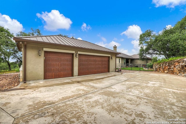 835 Shady Holw, New Braunfels, TX 78132 - view of front of house with a standing seam roof, stucco siding, driveway, metal roof, and an attached garage