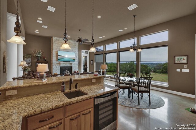 835 Shady Holw, New Braunfels, TX 78132 - kitchen with wine cooler, a sink, open floor plan, plenty of natural light, and recessed lighting