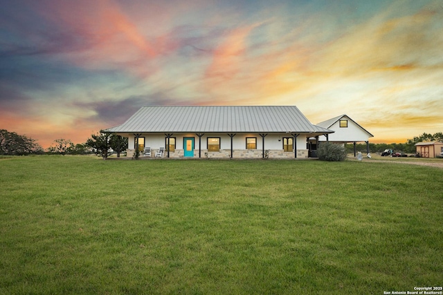 4355 N State Highway 16, Jourdanton, TX 78026 - view of front of home with a front lawn, stucco siding, stone siding, and a standing seam roof