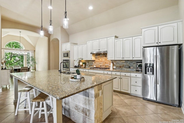 28534 Tristant Rdg, San Antonio, TX 78260 - kitchen with stainless steel appliances, vaulted ceiling, light tile patterned flooring, tasteful backsplash, and a sink
