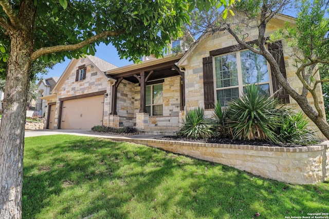 28534 Tristant Rdg, San Antonio, TX 78260 - view of front facade featuring stone siding, covered porch, a front yard, an attached garage, and concrete driveway