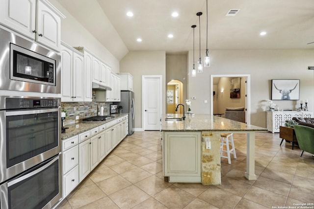 28534 Tristant Rdg, San Antonio, TX 78260 - kitchen with a sink, appliances with stainless steel finishes, under cabinet range hood, backsplash, and light tile patterned flooring