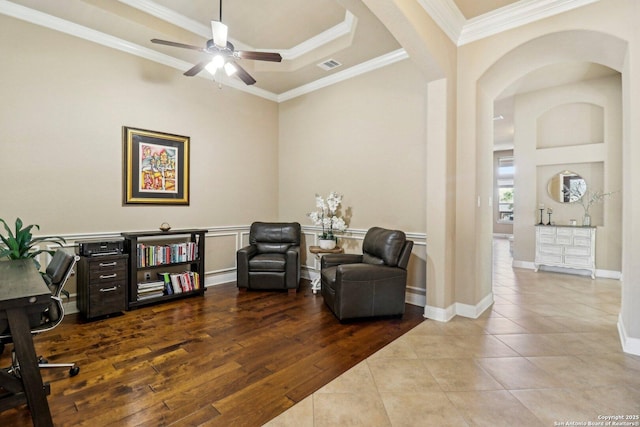 28534 Tristant Rdg, San Antonio, TX 78260 - living area with arched walkways, a ceiling fan, tile patterned flooring, ornamental molding, and a raised ceiling