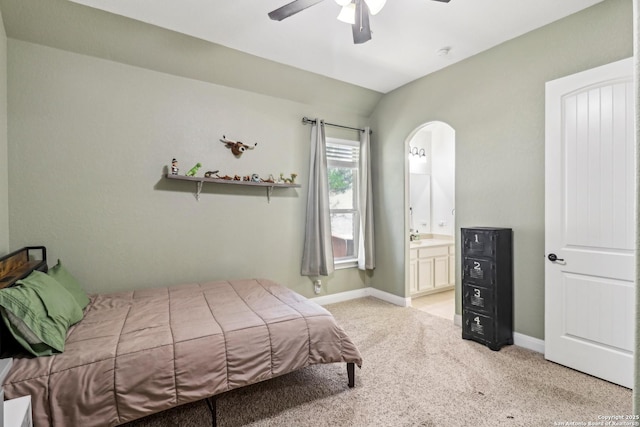 28534 Tristant Rdg, San Antonio, TX 78260 - bedroom with light colored carpet, ensuite bath, baseboards, ceiling fan, and arched walkways