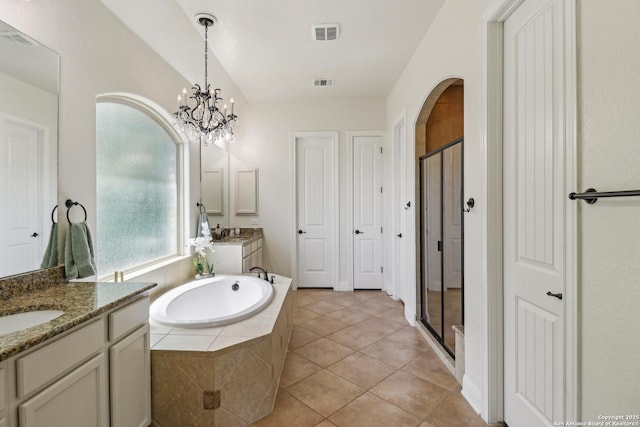 28534 Tristant Rdg, San Antonio, TX 78260 - bathroom featuring a stall shower, a bath, a chandelier, and tile patterned floors