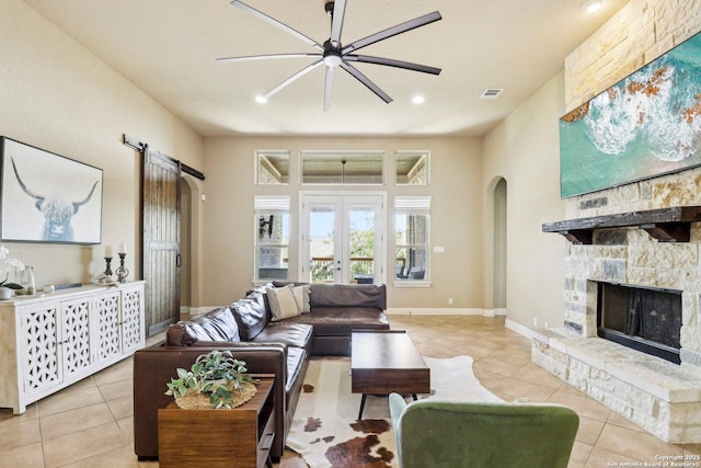 28534 Tristant Rdg, San Antonio, TX 78260 - living area featuring arched walkways, tile patterned floors, ceiling fan, a fireplace, and recessed lighting