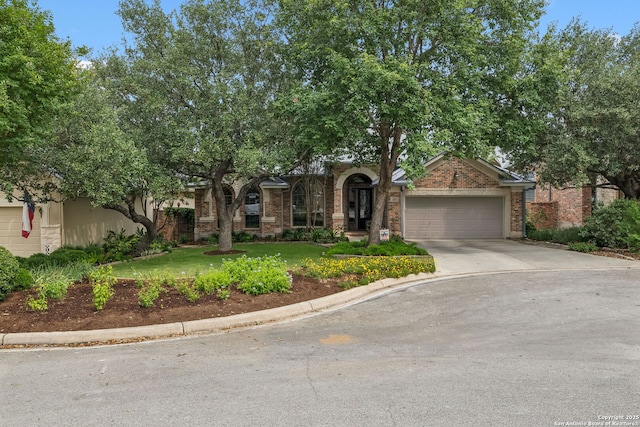 126 Calais Way, Shavano Park, TX 78249 - obstructed view of property with a garage, driveway, a front lawn, and brick siding