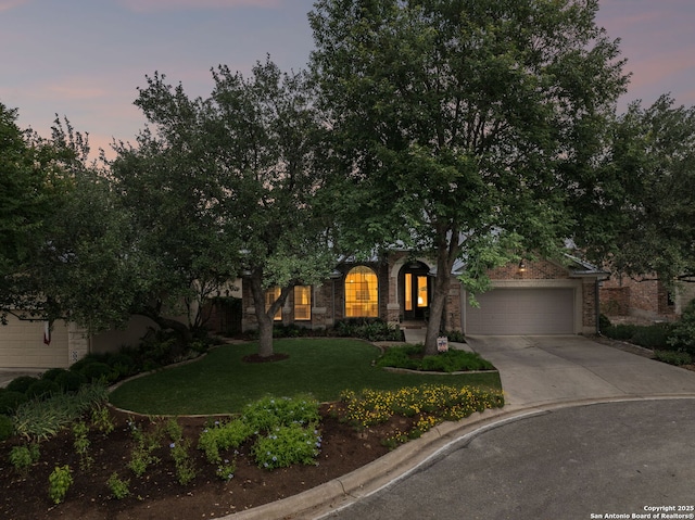 126 Calais Way, Shavano Park, TX 78249 - view of property hidden behind natural elements with a garage, driveway, and a front yard