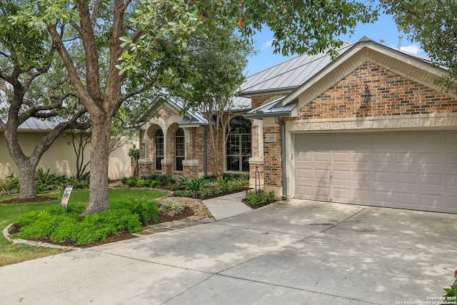 126 Calais Way, Shavano Park, TX 78249 - view of front of home featuring brick siding, driveway, a garage, and a standing seam roof
