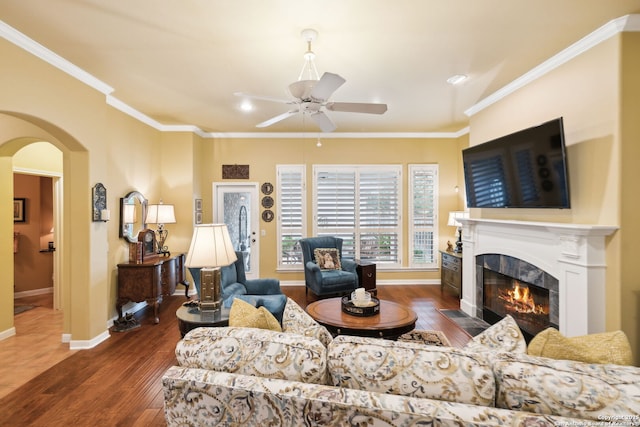 126 Calais Way, Shavano Park, TX 78249 - living area featuring ceiling fan, wood finished floors, ornamental molding, a fireplace with flush hearth, and arched walkways