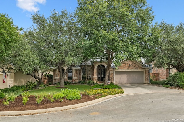 126 Calais Way, Shavano Park, TX 78249 - view of front of house featuring an attached garage, concrete driveway, a front lawn, and brick siding