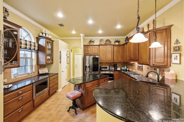 126 Calais Way, Shavano Park, TX 78249 - kitchen with stainless steel appliances, tasteful backsplash, brown cabinetry, ornamental molding, and arched walkways
