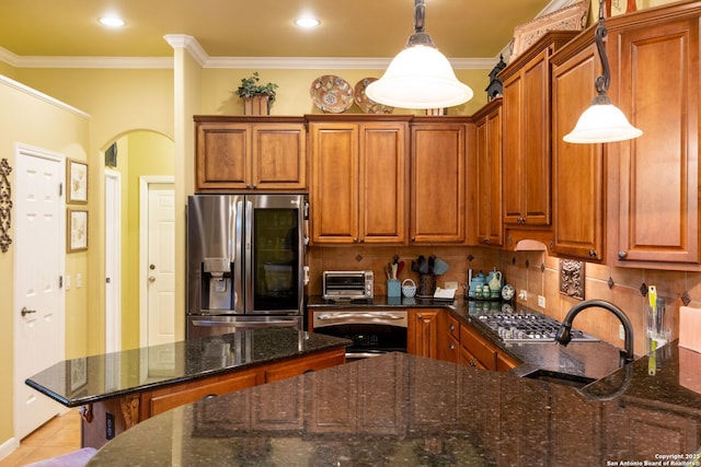 126 Calais Way, Shavano Park, TX 78249 - kitchen with appliances with stainless steel finishes, arched walkways, brown cabinetry, a sink, and crown molding