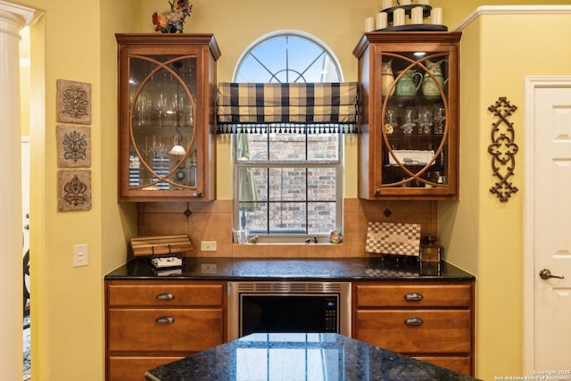 126 Calais Way, Shavano Park, TX 78249 - kitchen featuring glass insert cabinets, dark stone countertops, backsplash, and brown cabinets