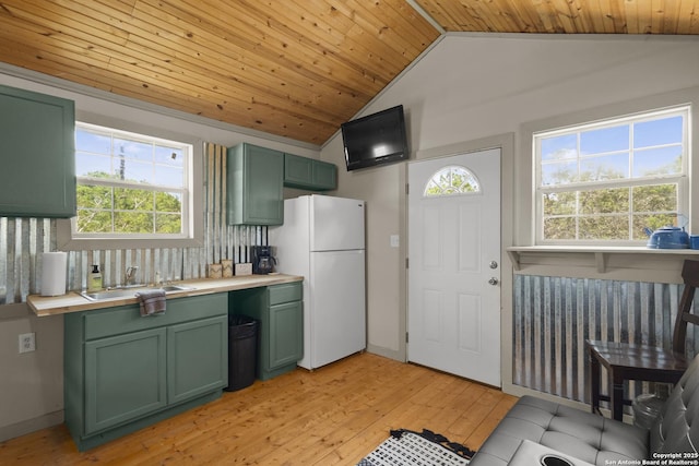 539 Rio Luna, Bandera, TX 78003 - kitchen featuring green cabinetry, a sink, freestanding refrigerator, light wood-style floors, and vaulted ceiling