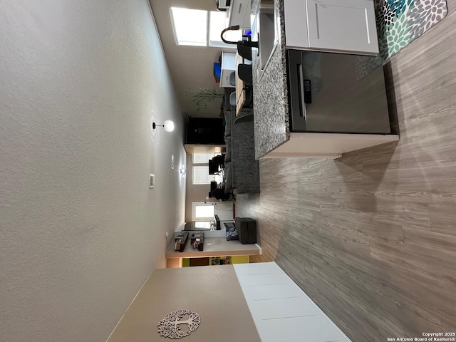 112 Agave Cir, Jourdanton, TX 78026 - corridor with a textured wall