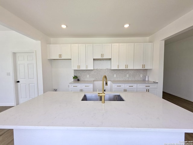 911 Florida, San Antonio, TX 78210 - kitchen with a sink, a center island with sink, white cabinets, backsplash, and dark wood-type flooring