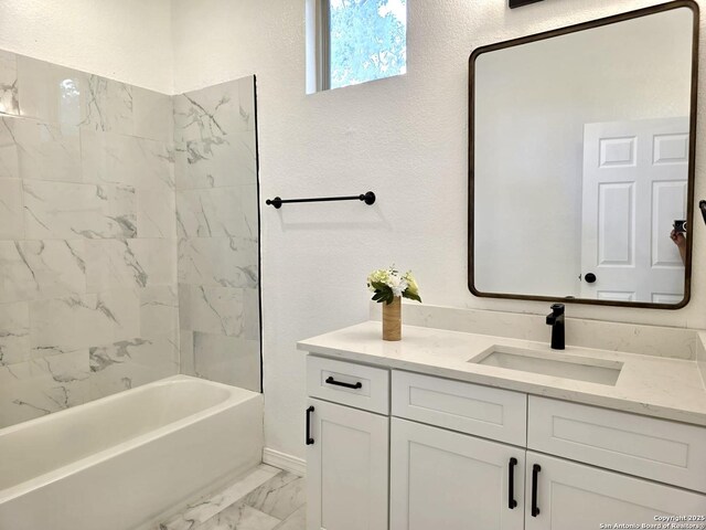 911 Florida, San Antonio, TX 78210 - full bathroom featuring marble look tiles, vanity, a textured wall, and bathtub / shower combination