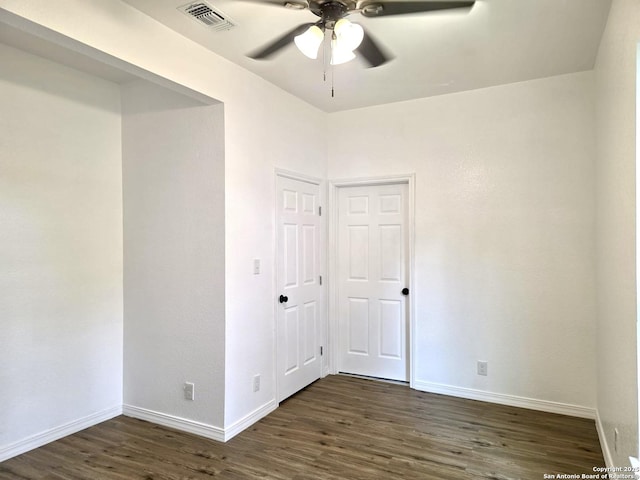 911 Florida, San Antonio, TX 78210 - unfurnished bedroom featuring baseboards, dark wood-type flooring, and ceiling fan
