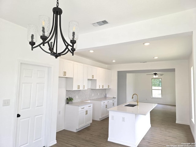 911 Florida, San Antonio, TX 78210 - kitchen with a sink, a center island with sink, white cabinets, tasteful backsplash, and recessed lighting