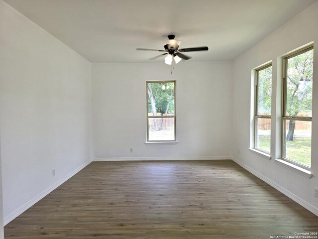 911 Florida, San Antonio, TX 78210 - spare room featuring healthy amount of natural light, wood finished floors, a ceiling fan, and baseboards