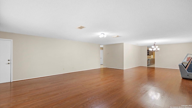 4714 Irish Elm, San Antonio, TX 78247 - unfurnished living room featuring a chandelier and wood finished floors