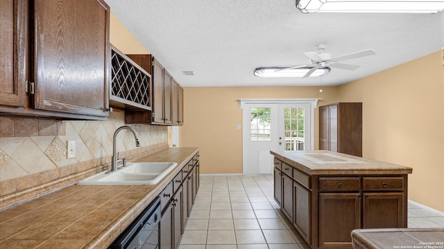 4714 Irish Elm, San Antonio, TX 78247 - kitchen featuring a sink, tile countertops, tasteful backsplash, dishwasher, and ceiling fan