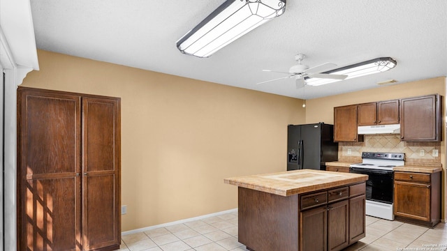 4714 Irish Elm, San Antonio, TX 78247 - kitchen with black refrigerator with ice dispenser, under cabinet range hood, electric stove, tasteful backsplash, and tile countertops
