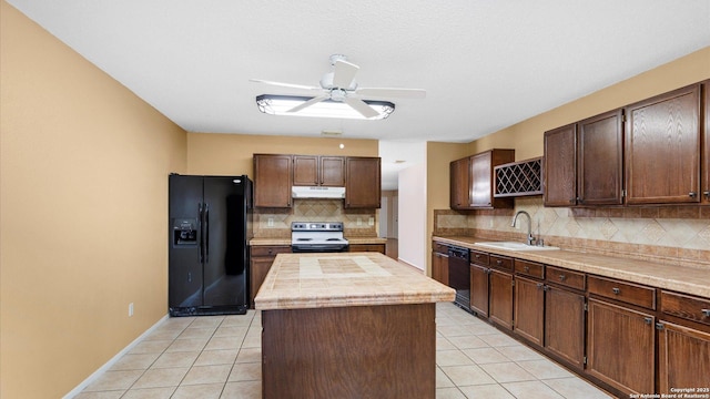 4714 Irish Elm, San Antonio, TX 78247 - kitchen with black appliances, a center island, a sink, under cabinet range hood, and backsplash
