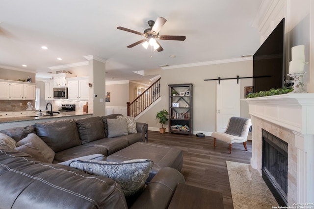 13314 Galicia, Universal City, TX 78148 - living room featuring a ceiling fan, ornamental molding, dark wood-style flooring, stairs, and a tiled fireplace