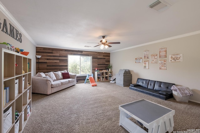 13314 Galicia, Universal City, TX 78148 - living room featuring ornamental molding, carpet flooring, wood walls, and a ceiling fan